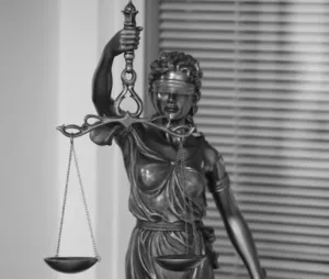Elegant black and white photo of Lady Justice statue, symbolizing fairness and law.