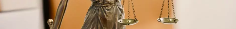Close-up of Lady Justice statue holding scales, symbolizing justice and fairness.